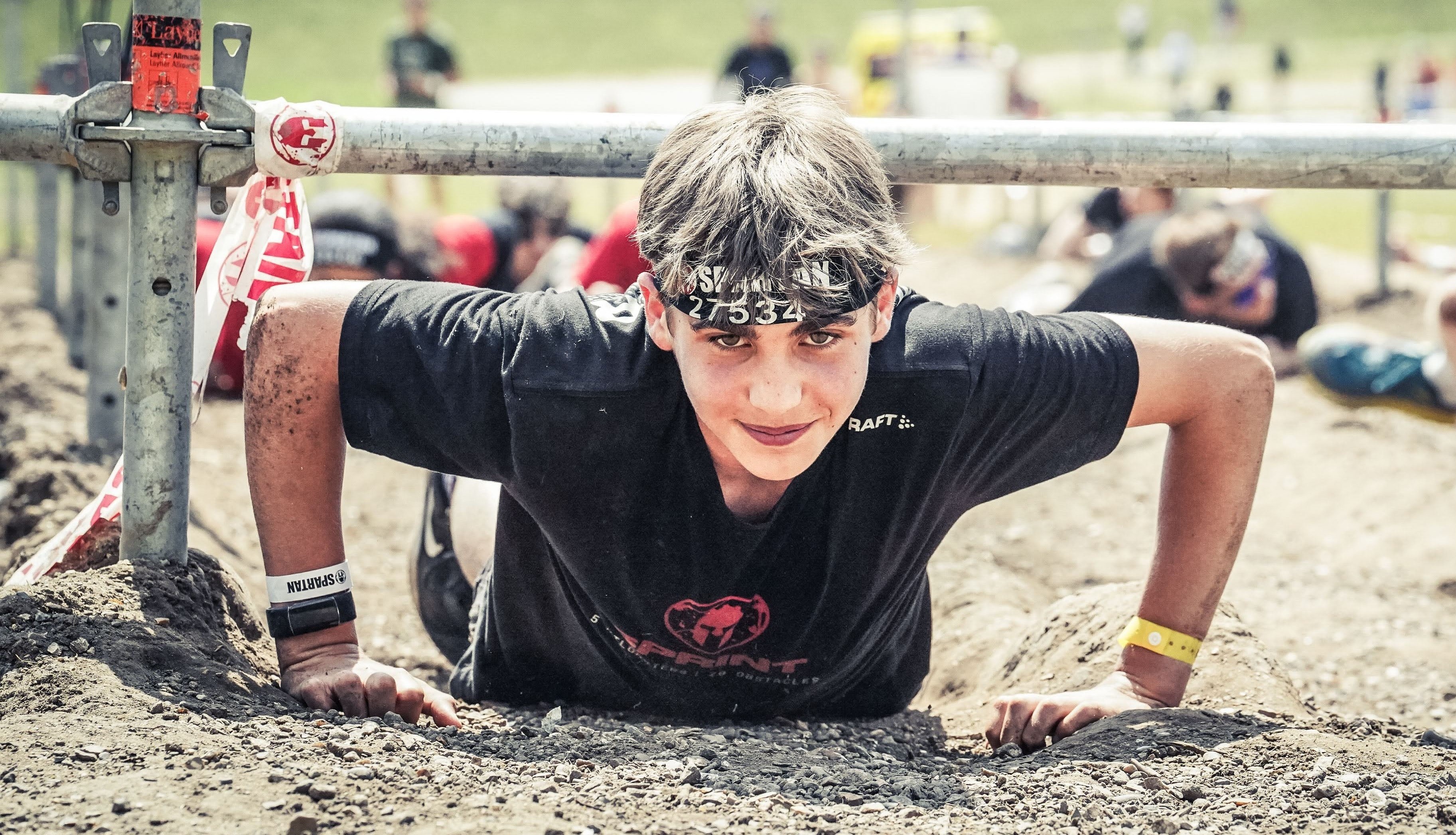 Tom looking up during a barbed-wire crawl