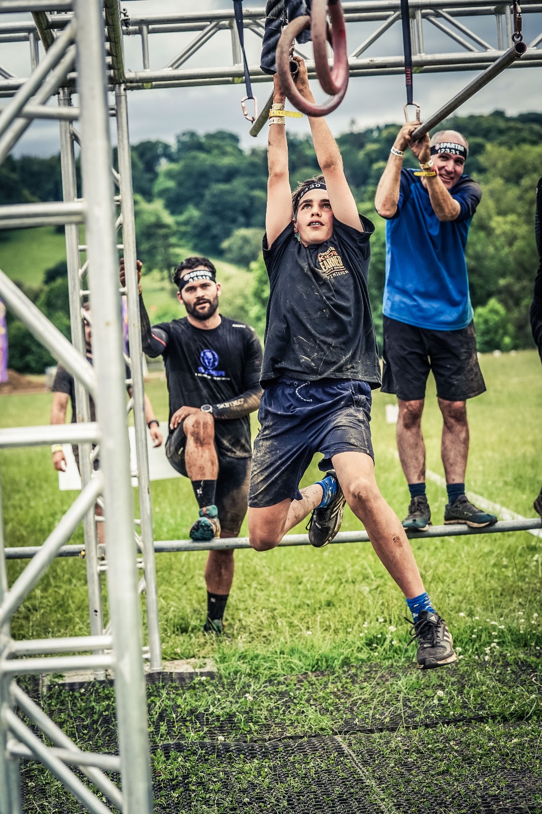 Tom completing monkey bars in a Spartan race