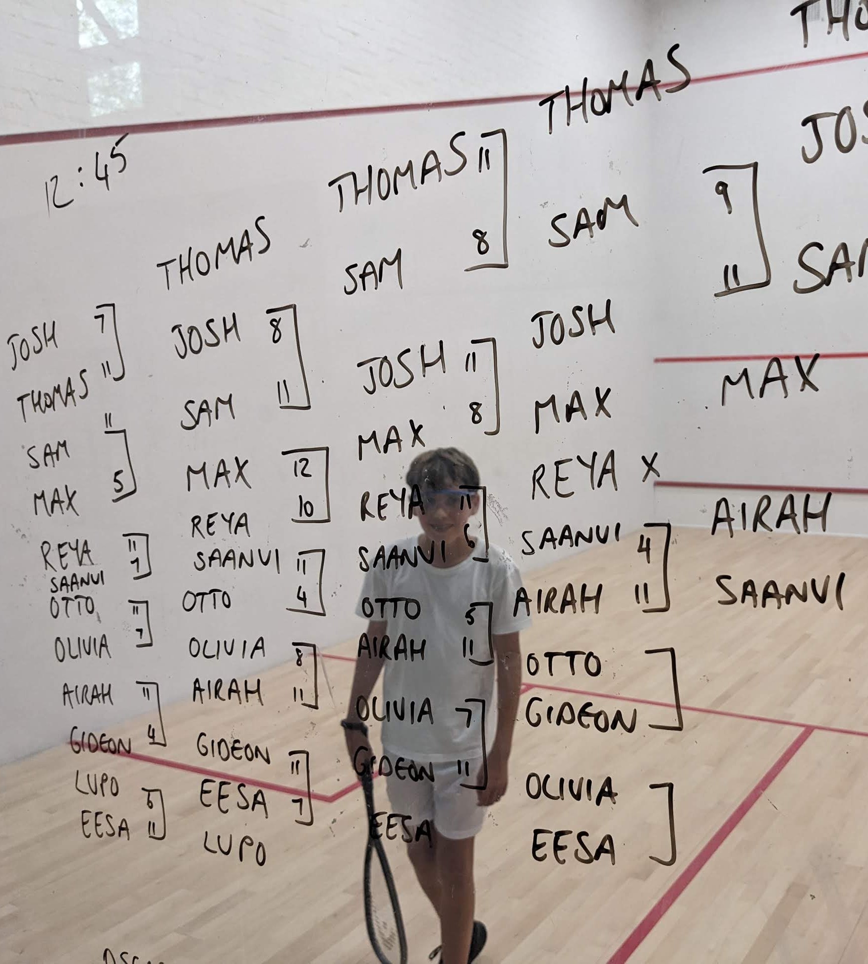 Tom playing in a squash tournament
