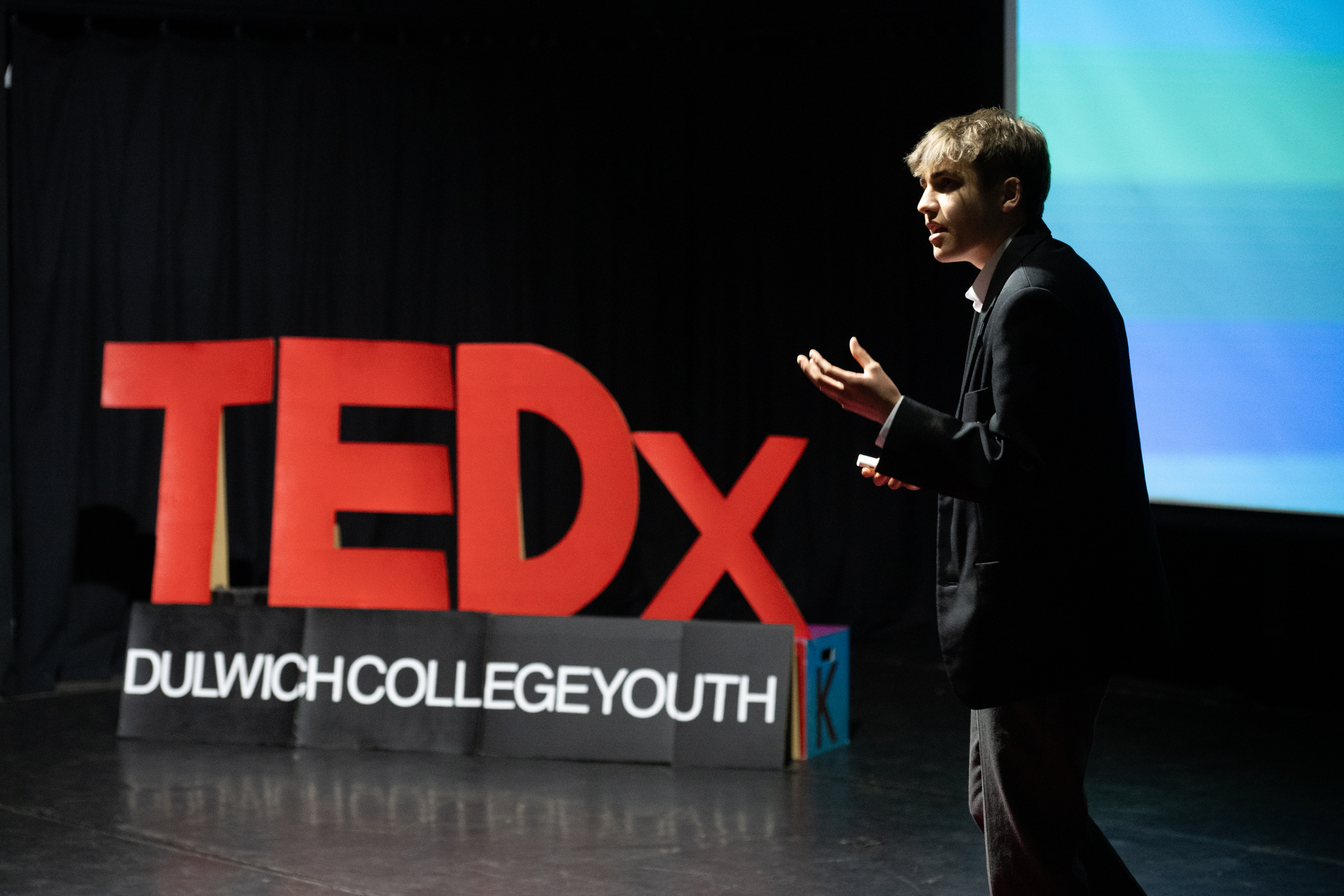 Tom speaking on a TEDx stage